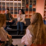 A group of people discussing books that look far more studious than we ever will